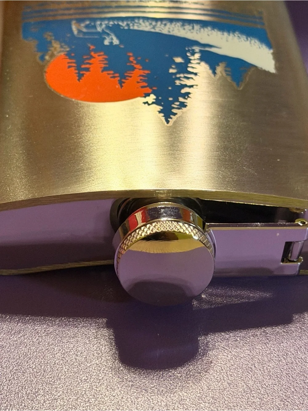 Ozark Trail Silver Hip Flask with Blue Forest and Orange Sun Design